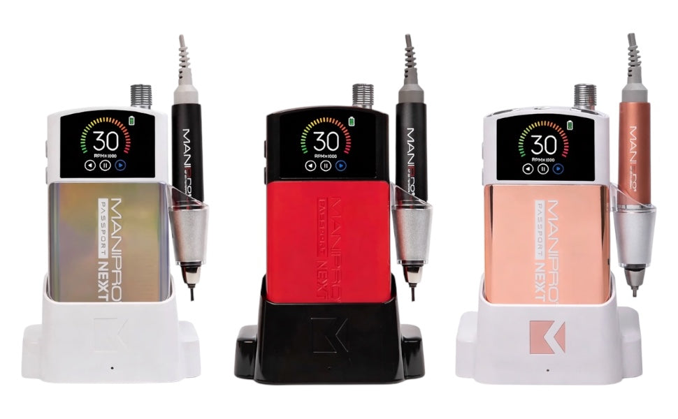 KUPA MANIPro Passport NEXT nail drill shown in three colors — Unicorn, red, and Rose Gold — each in a charging dock with handpiece