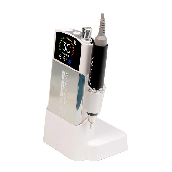KUPA MANIPro Passport NEXT nail drill in Unicorn holographic chrome finish, angled side view in white charging dock with handpiece